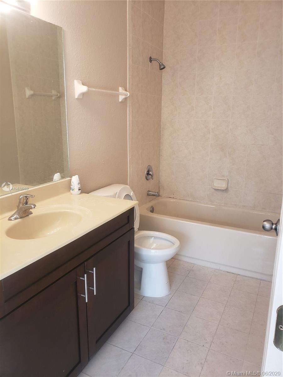2551 Southeast 16th Terrace, Unit 104 Homestead, FL 33035 - Photo 4 of 7 a bathroom with a sink a toilet and a bathtub