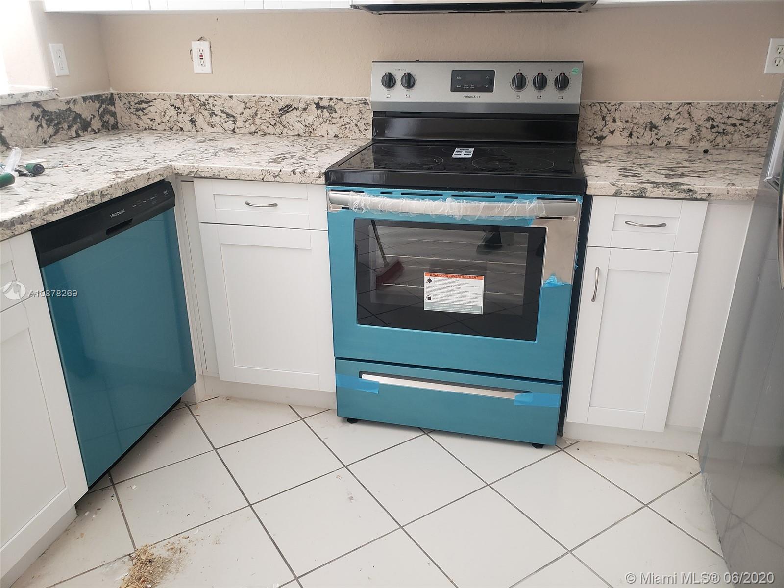2551 Southeast 16th Terrace, Unit 104 Homestead, FL 33035 - Photo 7 of 7 a stove top oven sitting inside of a kitchen