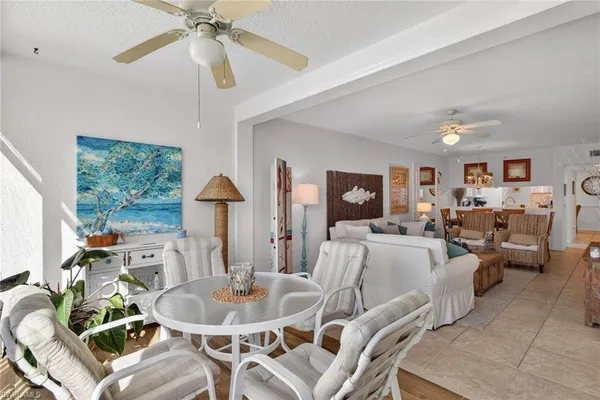 a living room with furniture a couch and a chandelier