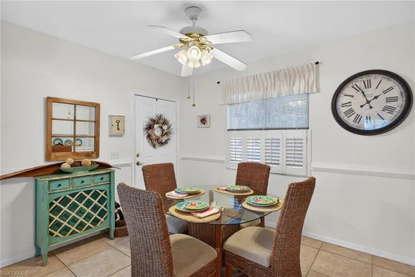 a view of a dining room with furniture a rug and wooden floor