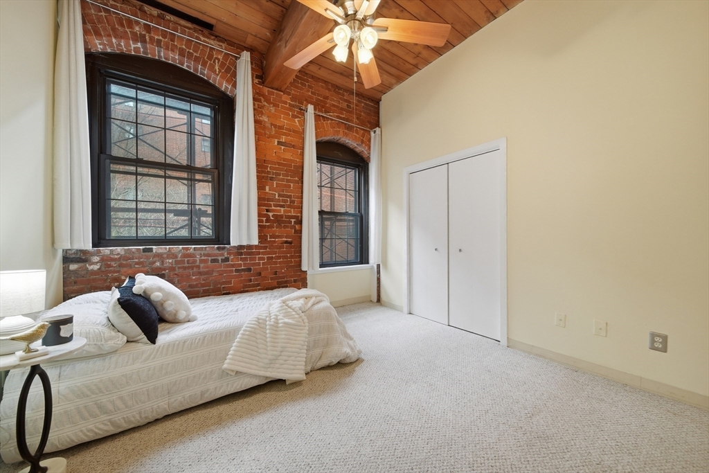 50 Rantoul Street, Unit 204 Beverly, MA 01915 - Photo 17 of 41 a bedroom with a bed and a window
