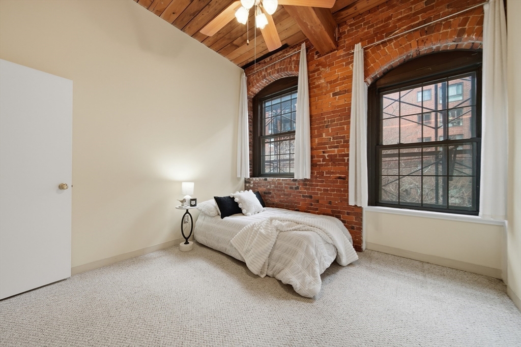 50 Rantoul Street, Unit 204 Beverly, MA 01915 - Photo 18 of 41 a bedroom with a bed and a large window
