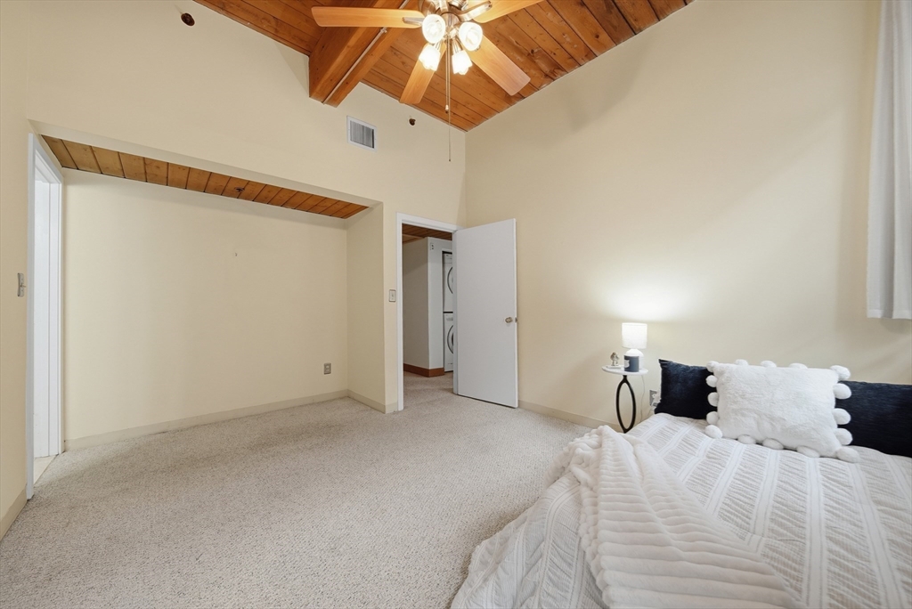50 Rantoul Street, Unit 204 Beverly, MA 01915 - Photo 20 of 41 a bed room with a bed and a ceiling fan