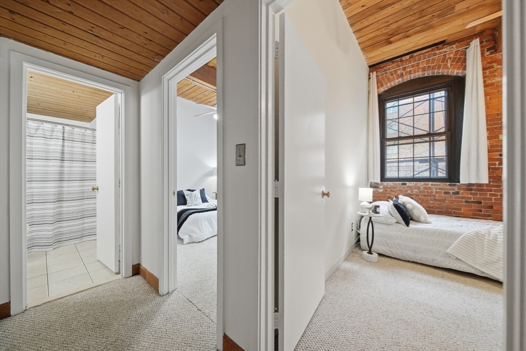 50 Rantoul Street, Unit 204 Beverly, MA 01915 - Photo 21 of 41 a bedroom with furniture and a window