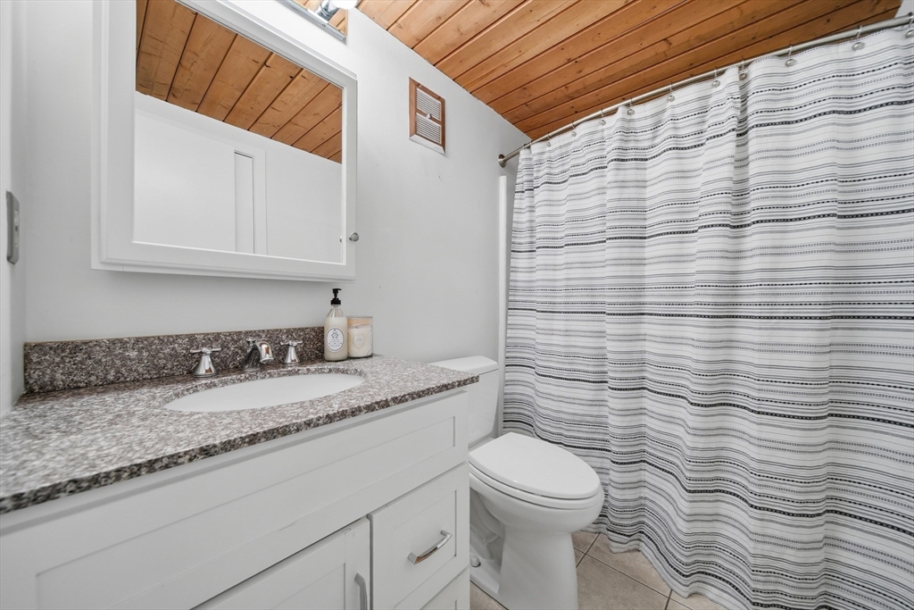 50 Rantoul Street, Unit 204 Beverly, MA 01915 - Photo 22 of 41 a bathroom with a granite countertop toilet and sink