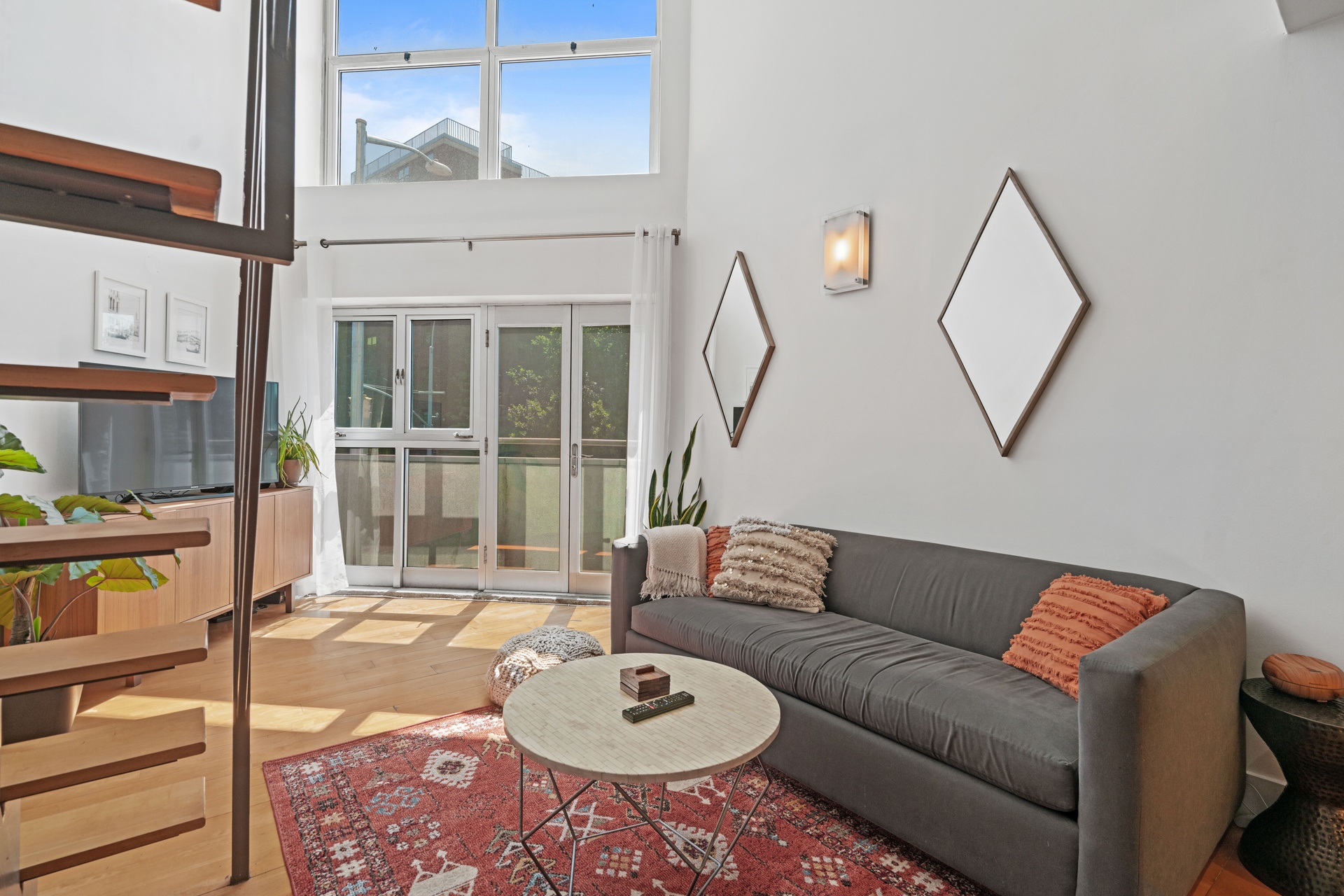 96 Woodpoint Road, Unit 2C Brooklyn, NY 11211 - Photo 4 of 9 a living room with furniture a rug and a floor to ceiling window