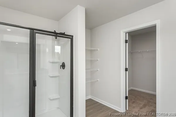 a bathroom with a glass shower door
