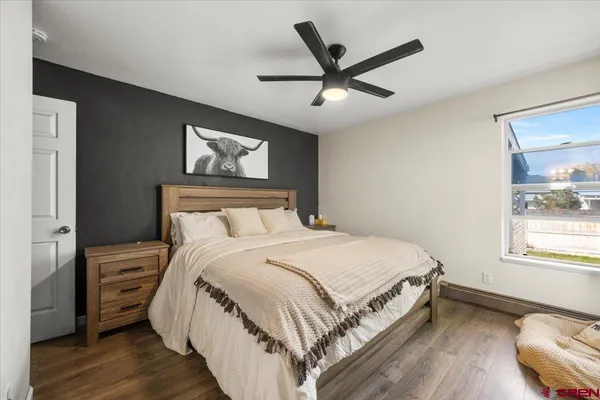 a bedroom with a large bed and a window