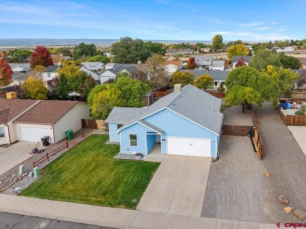 an aerial view of residential houses with outdoor space