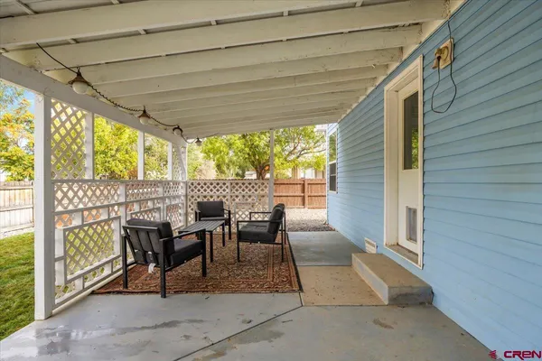 a view of a patio with table and chairs