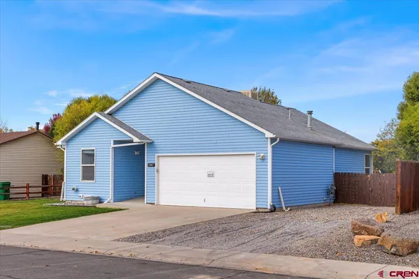 a view of garage yard and front view of a house