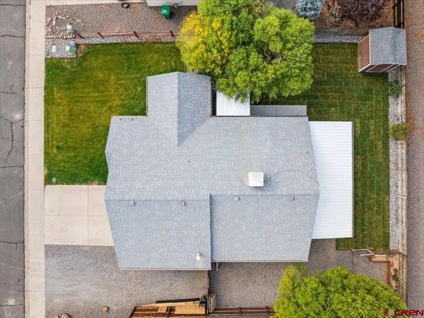 an aerial view of a house with a yard