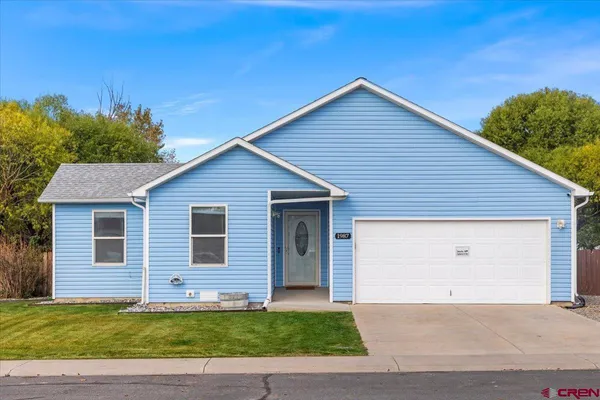 a view of a house with a yard and garage