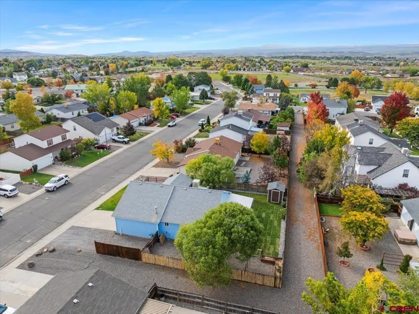 an aerial view of residential houses with outdoor space