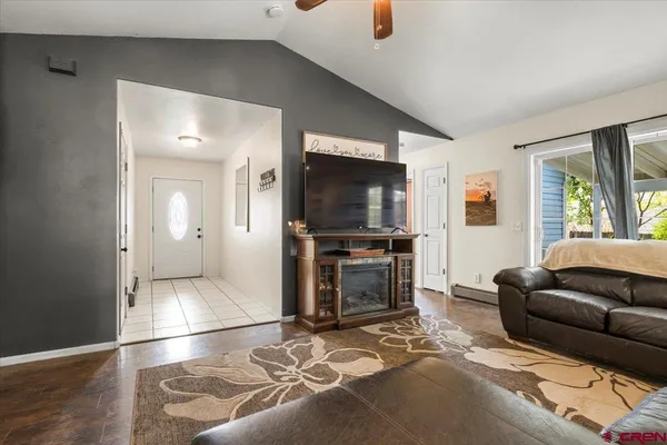 a living room with furniture and a flat screen tv