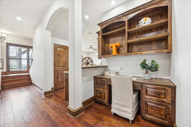 a view of a hallway with entryway and wooden floor