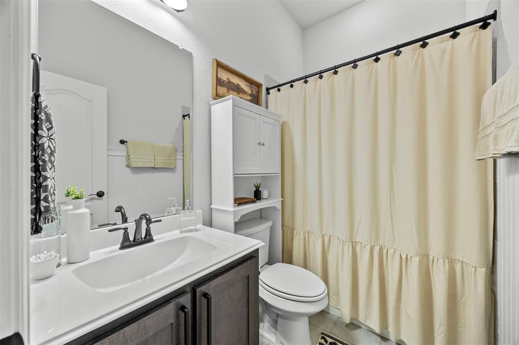1084 Imperial Eagle Road Alvarado, TX 76009 - Photo 29 of 39 a bathroom with a sink a toilet and a mirror