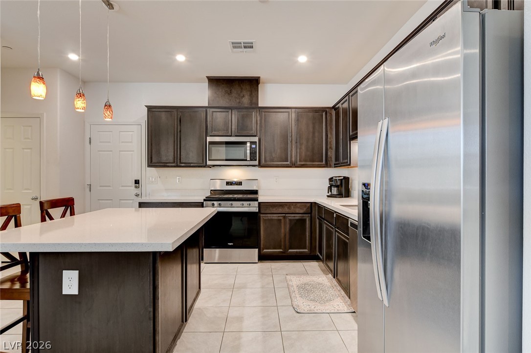 484 Filaree Place Henderson, NV 89015 - Photo 17 of 71 This contemporary kitchen features abundant cabinet storage, a functional island, and essential modern appliances.