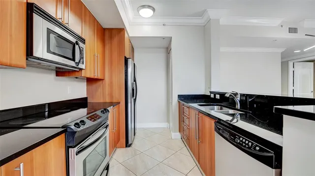 a bathroom with a granite countertop sink a large mirror and a shower