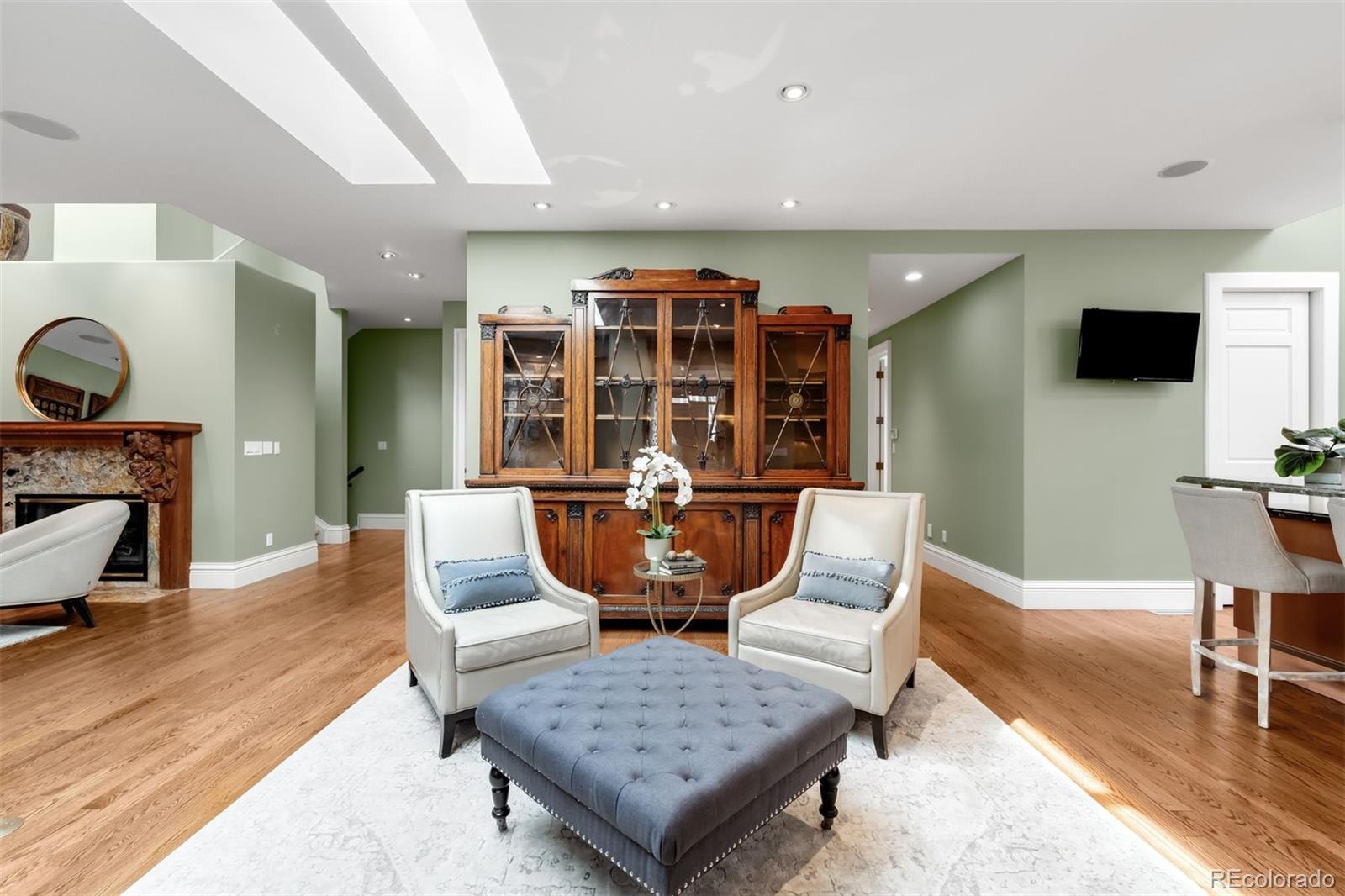 465 Monroe Street Denver, CO 80206 - Photo 16 of 47 a living room with furniture a flat screen tv and kitchen view