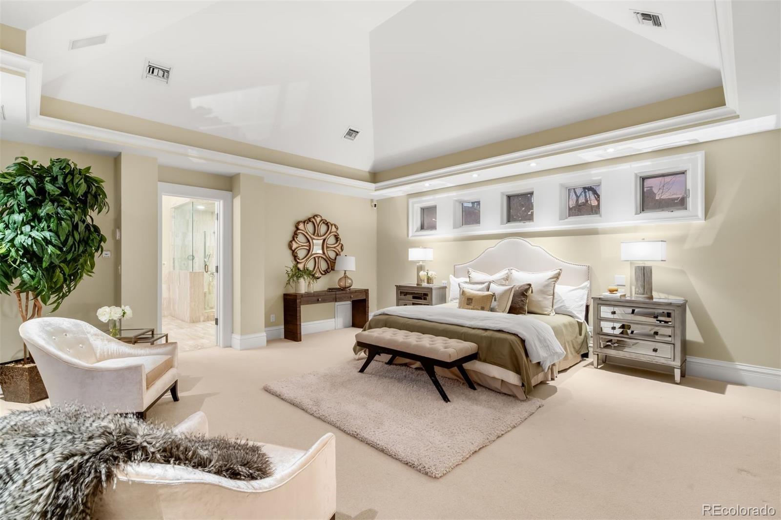 465 Monroe Street Denver, CO 80206 - Photo 27 of 47 a spacious bedroom with a bed and a potted plant