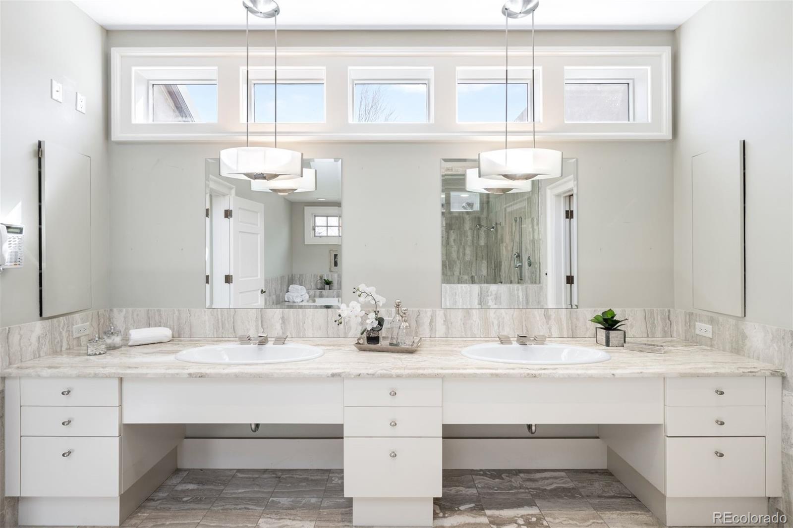 465 Monroe Street Denver, CO 80206 - Photo 30 of 47 a bathroom with double vanity and a mirror