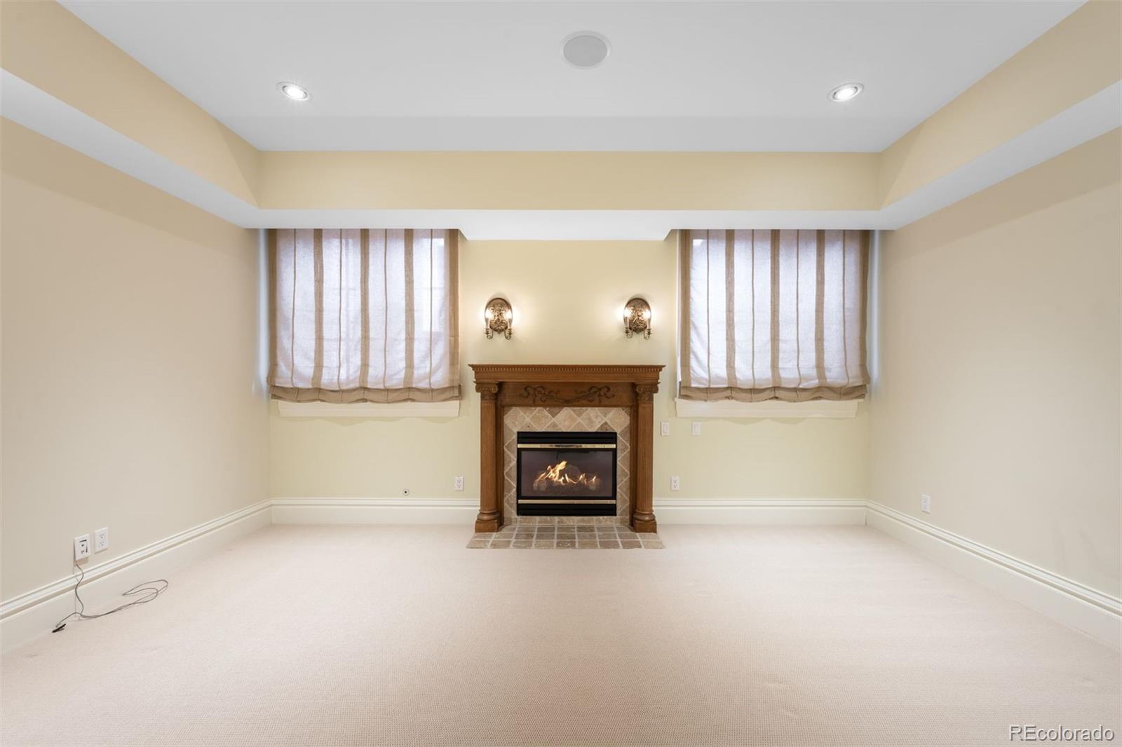 465 Monroe Street Denver, CO 80206 - Photo 37 of 47 an empty room with a fireplace and windows