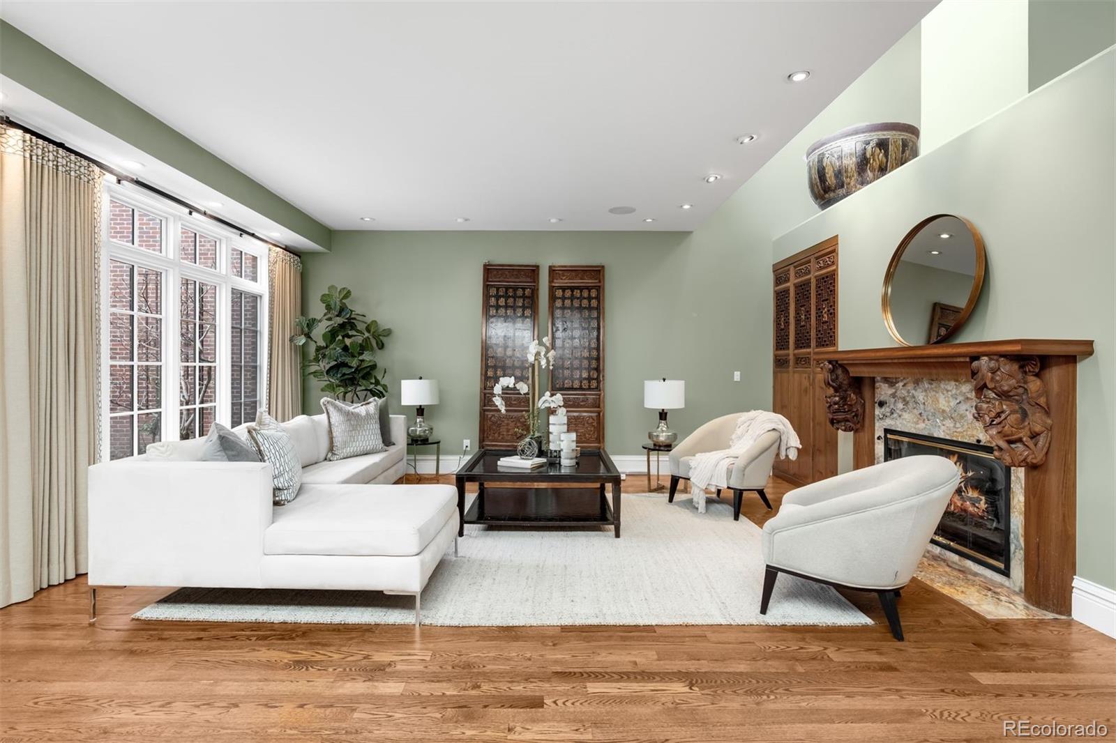 465 Monroe Street Denver, CO 80206 - Photo 4 of 47 a living room with fireplace furniture and a large window