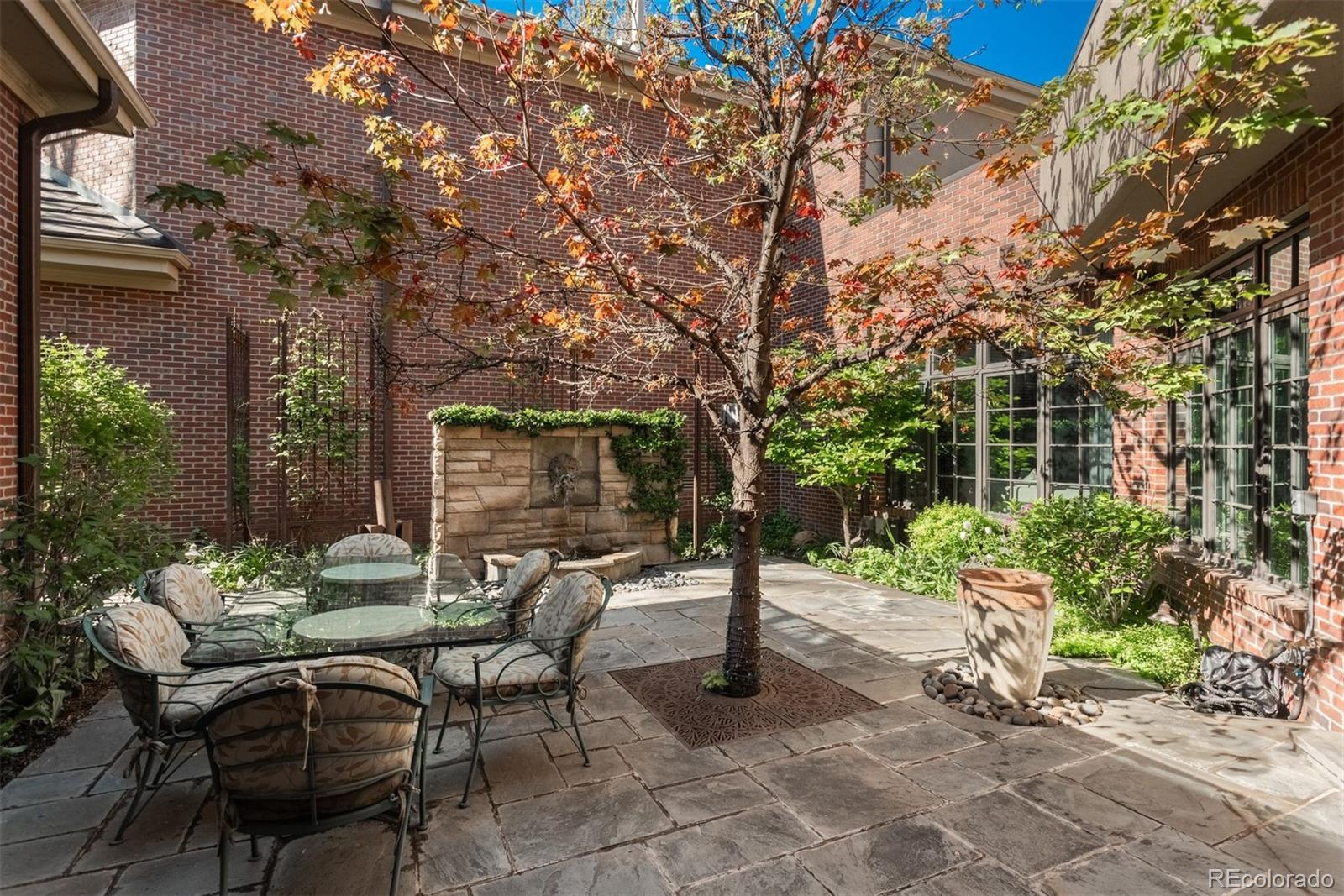 465 Monroe Street Denver, CO 80206 - Photo 5 of 47 a patio with table and chairs and potted plants