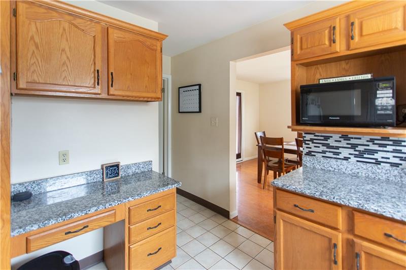 12249 Roth Drive North Huntingdon, PA 15642 - Photo 7 of 24 Kitchen with granite counters and tiled backsplash
