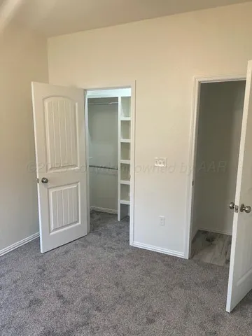 an empty room with closet area