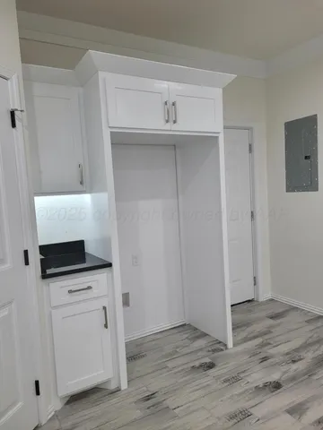a view of cabinets and wooden floor