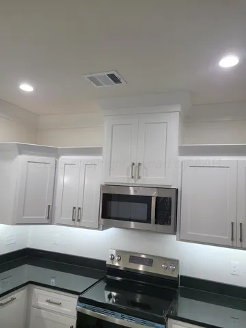 a kitchen with a stove and a microwave
