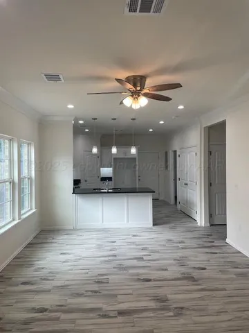 a view of a kitchen with a sink and a window