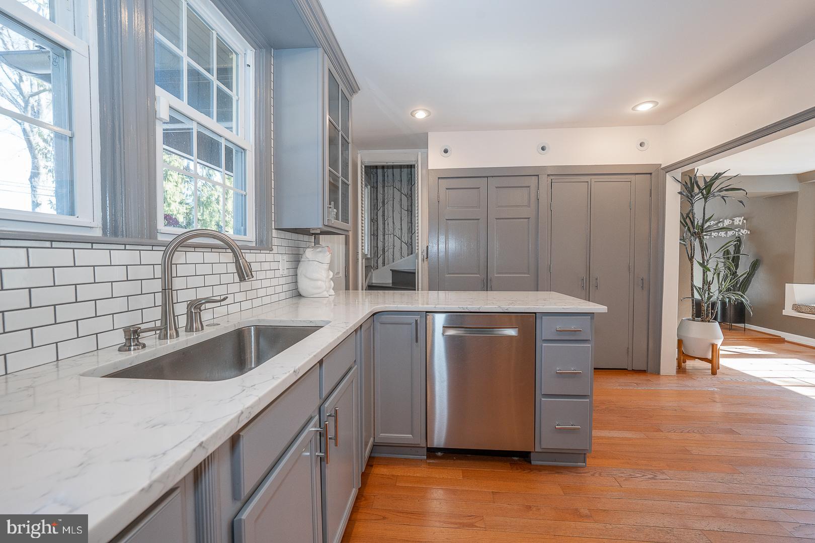 108 South Spring Mill Road Villanova, PA 19085 - Photo 11 of 53 a kitchen with stainless steel appliances granite countertop a sink a counter space and wooden floor
