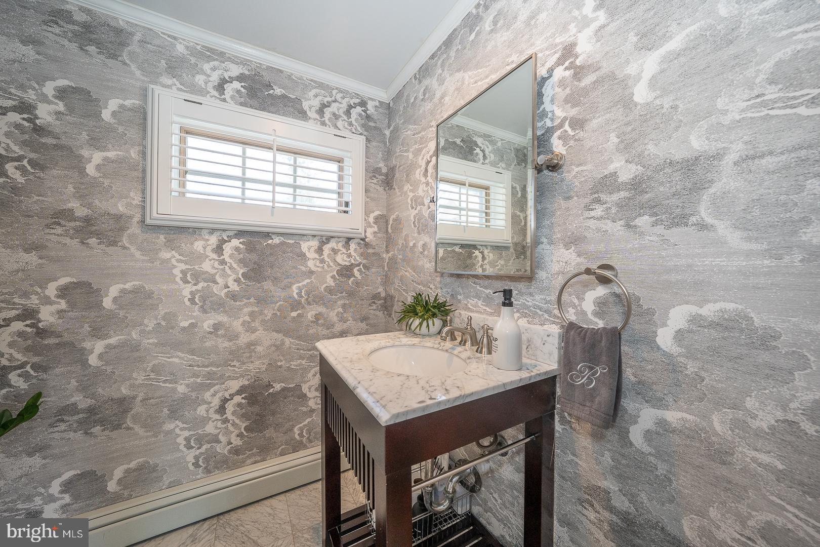 108 South Spring Mill Road Villanova, PA 19085 - Photo 15 of 53 a bathroom with a sink a mirror and a window