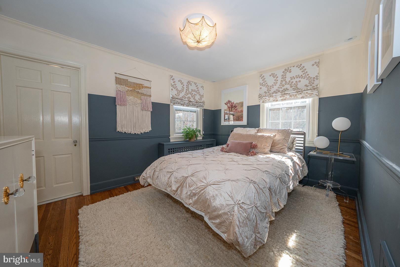 108 South Spring Mill Road Villanova, PA 19085 - Photo 30 of 53 a bedroom with a bed and a chandelier