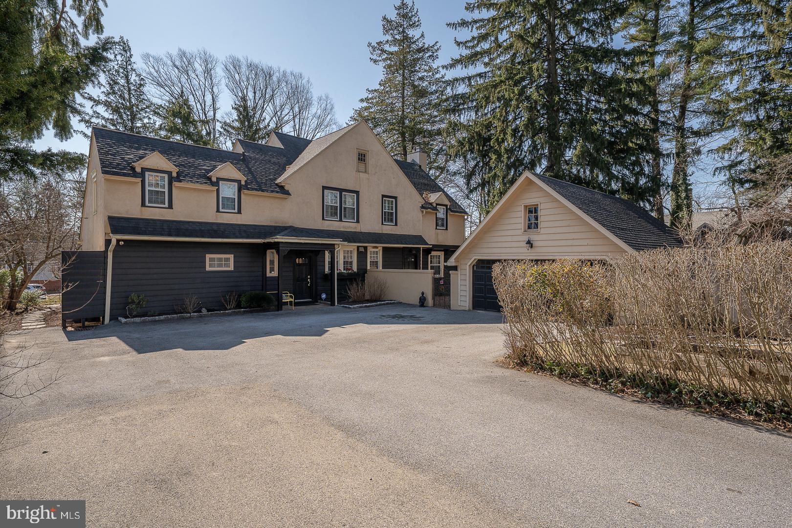 108 South Spring Mill Road Villanova, PA 19085 - Photo 44 of 53 a front view of a house with a yard and garage