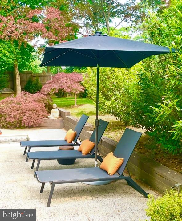 108 South Spring Mill Road Villanova, PA 19085 - Photo 47 of 53 a view of a backyard with chairs under an umbrella