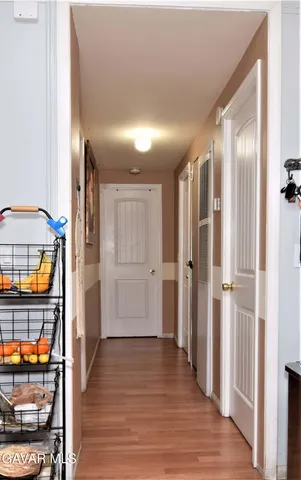 a view of a room with wooden floor and door