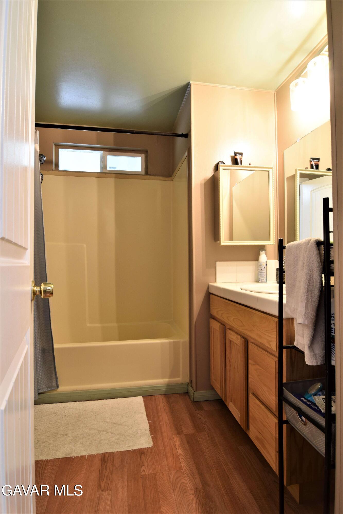 45446 7th Street East Lancaster, CA 93535 - Photo 13 of 21 a bathroom with a shower and a tub