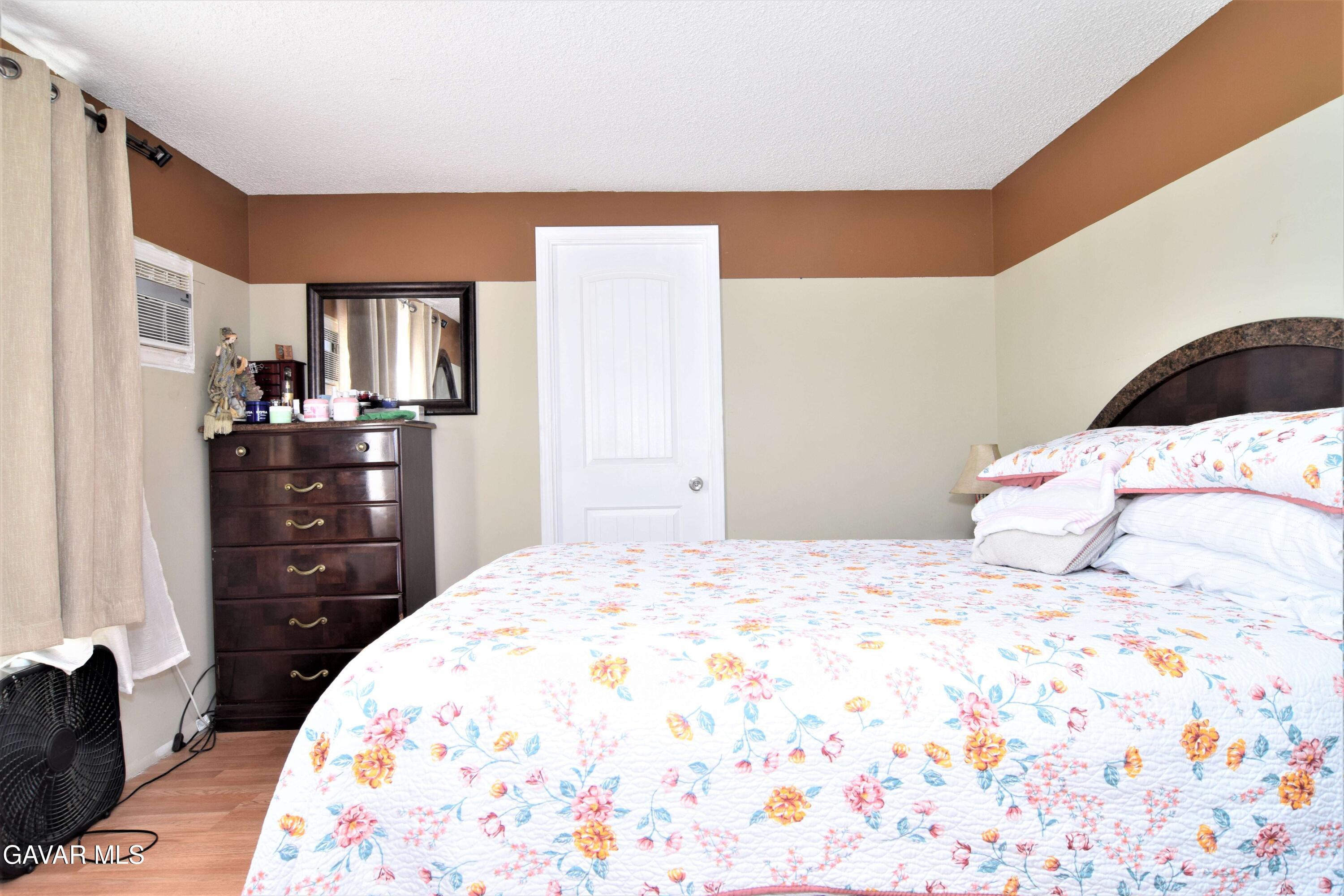 45446 7th Street East Lancaster, CA 93535 - Photo 14 of 21 a bedroom with a bed and dresser