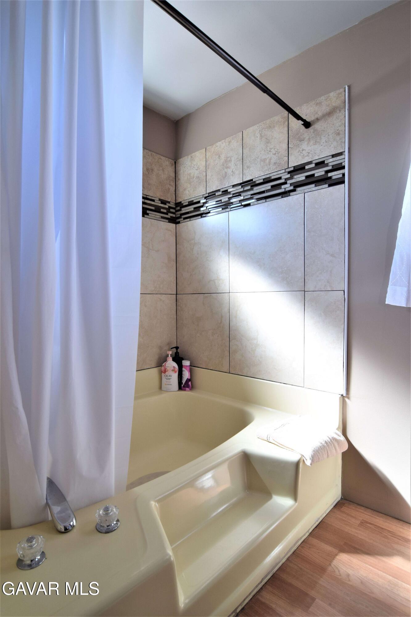 45446 7th Street East Lancaster, CA 93535 - Photo 17 of 21 a bathroom with a bathtub and a shower