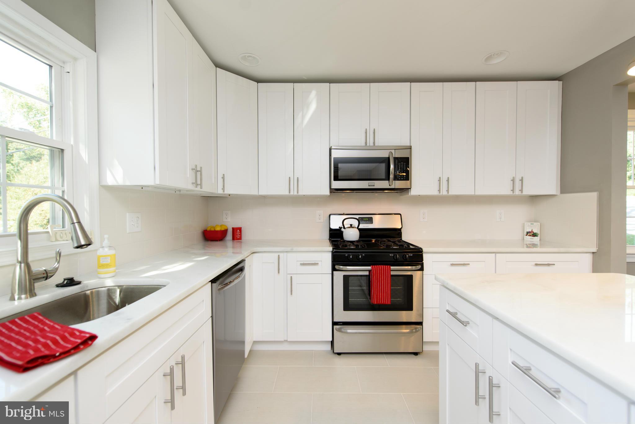 1530 South Rolling Road Halethorpe, MD 21227 - Photo 14 of 30 a kitchen with stainless steel appliances granite countertop a sink and a stove