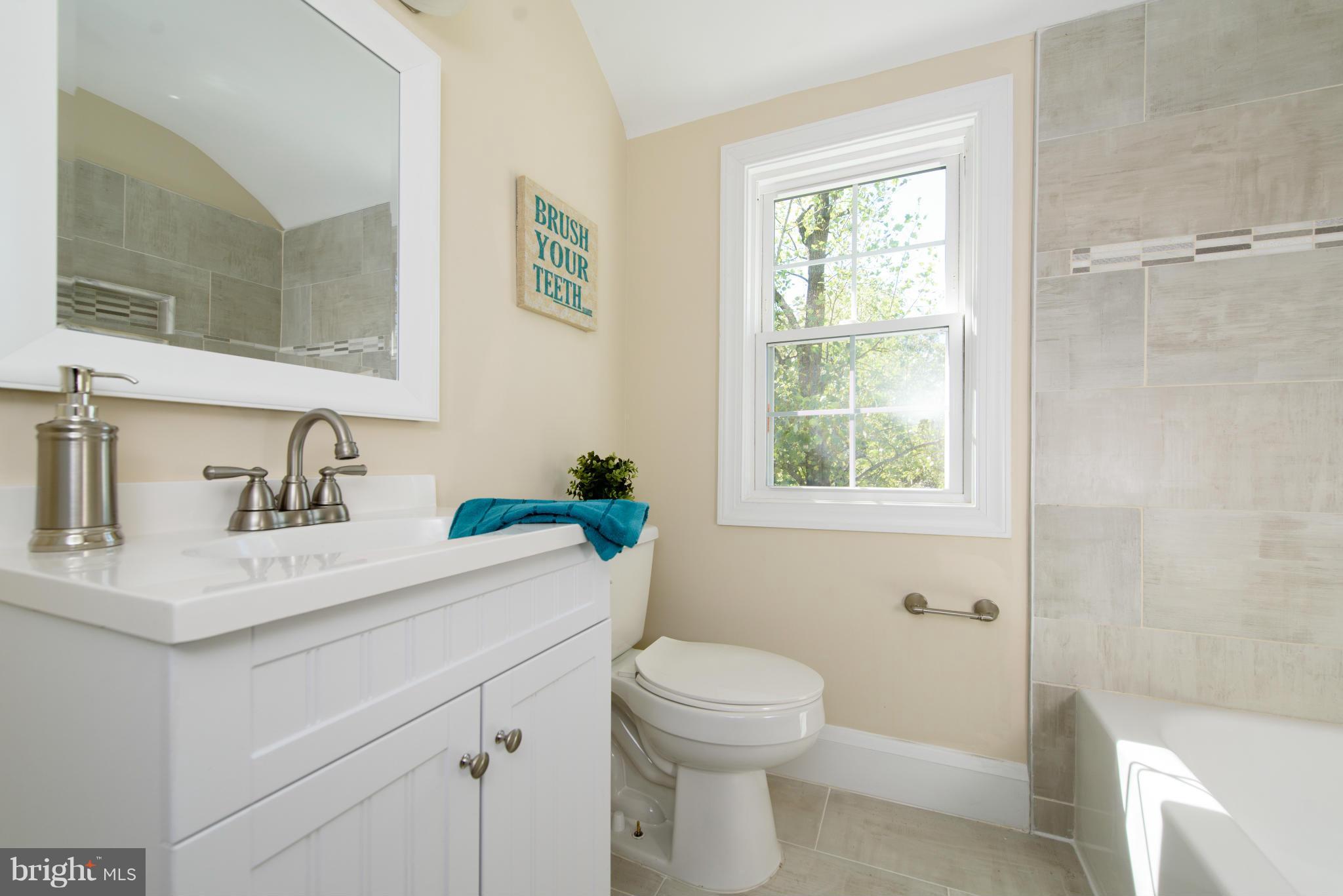 1530 South Rolling Road Halethorpe, MD 21227 - Photo 22 of 30 a bathroom with a sink a toilet and a window