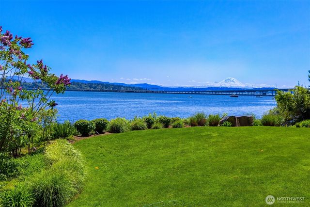 a front view of a house with potted plants