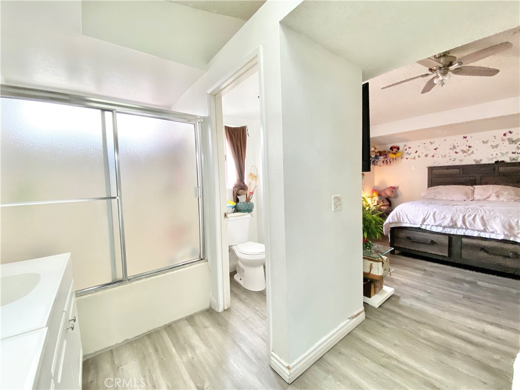 1444 North Sage Avenue Rialto, CA 92376 - Photo 15 of 22 a bedroom with a bed and a wooden floor