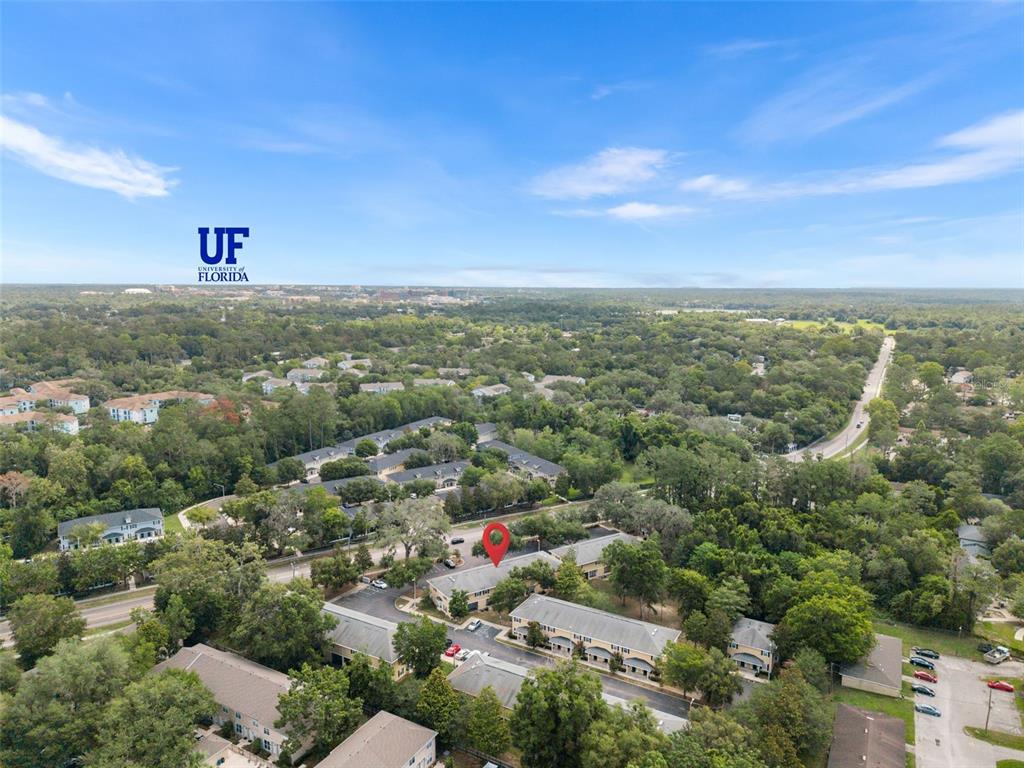 2927 Southwest 35th Place, Unit 113 Gainesville, FL 32608 - Photo 2 of 27 an aerial view of residential building and green space