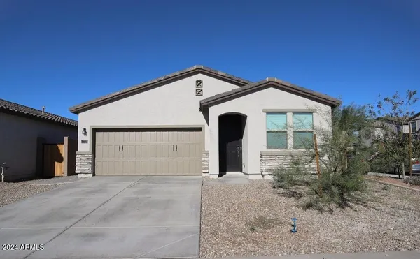 a view of a house with a yard and garage
