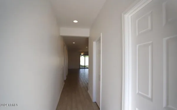 a view of a hallway with wooden floor